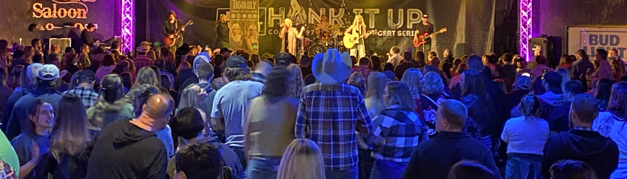 country concert with fans wearing cowboy hats Fresno